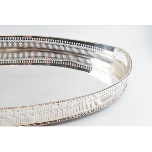 310W - Large Edwardian silver plated oval gallery tray with handles, 61cm wide.