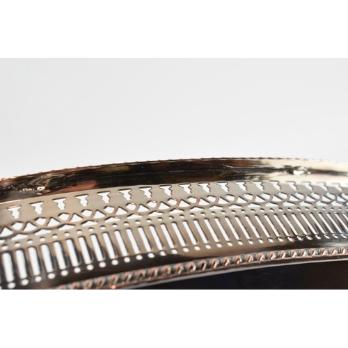 310W - Large Edwardian silver plated oval gallery tray with handles, 61cm wide.