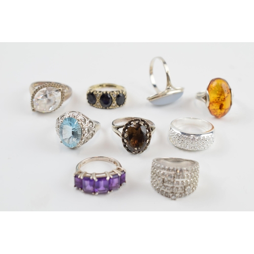 405A - A collection of silver dress rings of varying sizes and forms (9).