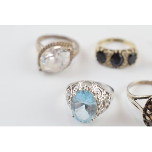 405A - A collection of silver dress rings of varying sizes and forms (9).