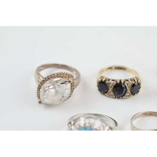 405A - A collection of silver dress rings of varying sizes and forms (9).