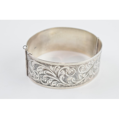 405B - Silver wide bangle with scroll decoration to ront and back, Birmingham 1933, 35.4 grams.