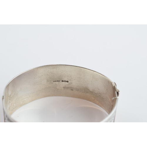 405B - Silver wide bangle with scroll decoration to ront and back, Birmingham 1933, 35.4 grams.