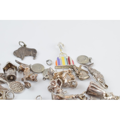 405C - A collection of mainly silver charms of varying forms and sizes, approx. 90 grams.