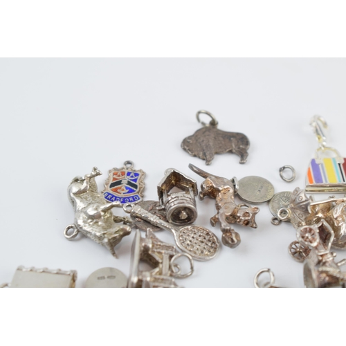 405C - A collection of mainly silver charms of varying forms and sizes, approx. 90 grams.