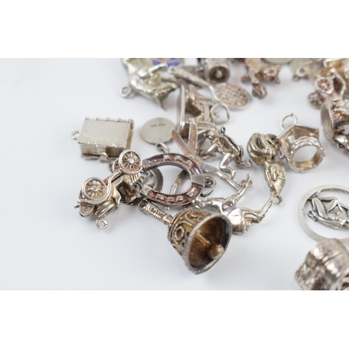 405C - A collection of mainly silver charms of varying forms and sizes, approx. 90 grams.