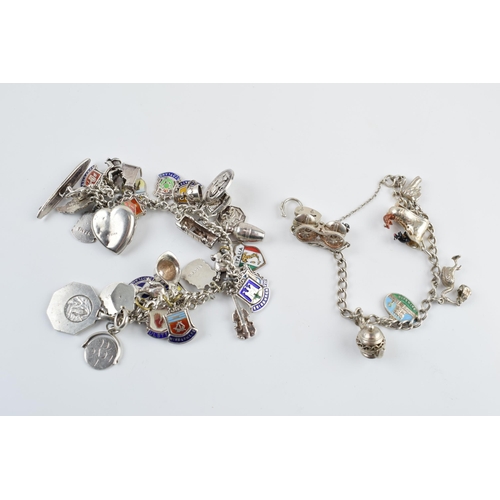 405F - A pair of silver charm bracelets with various charms, circa 99 grams (2).