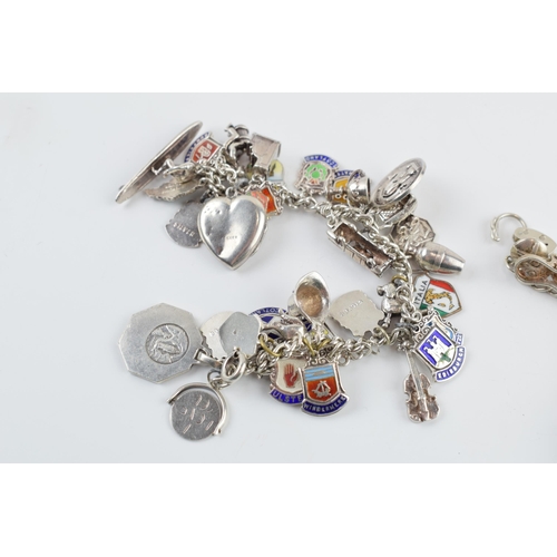 405F - A pair of silver charm bracelets with various charms, circa 99 grams (2).