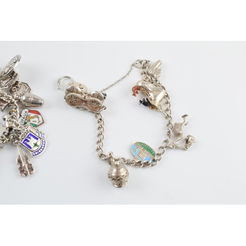 405F - A pair of silver charm bracelets with various charms, circa 99 grams (2).