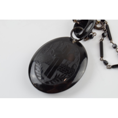 405H - Jet mourning locket on chain, slight chip to top of locket.