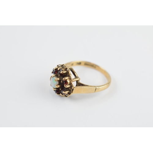 405O - 9ct gold ring set with opal and garnets, 3.4 grams, size N/O.