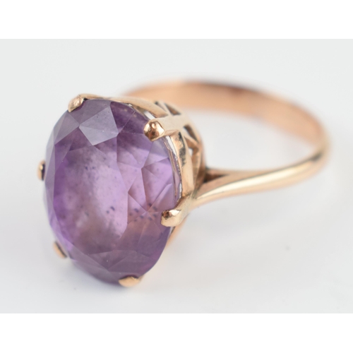 405Q - Yellow metal (tests as 9ct gold) ladies ring with large amethyst, gross weight 7.3 grams, size V/W.