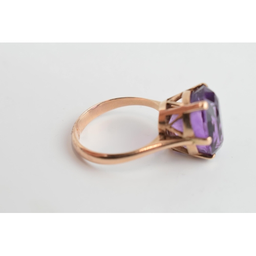 405Q - Yellow metal (tests as 9ct gold) ladies ring with large amethyst, gross weight 7.3 grams, size V/W.