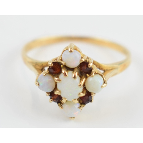 405R - 9ct gold dress ring set with opals and garnets, 1.6 grams, size O.