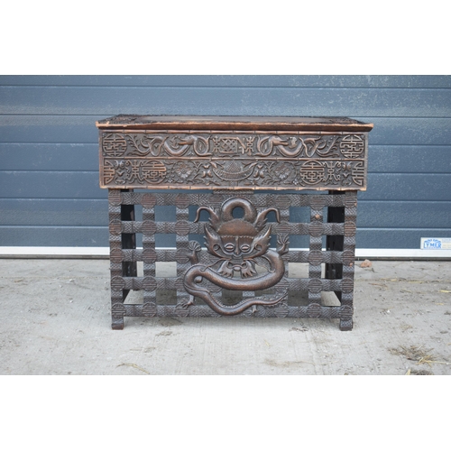 436 - Antique Chinese carved alter table with folding legs with carved figural decoration with character m... 