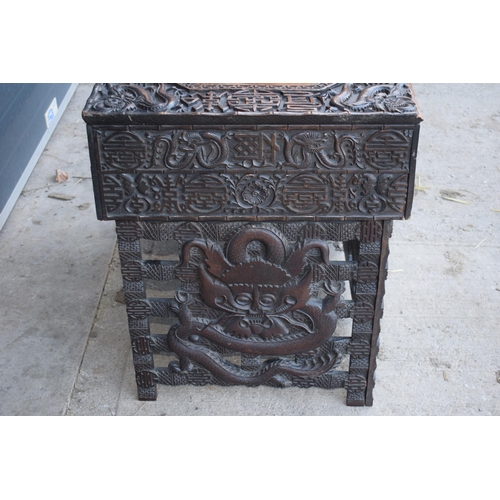 436 - Antique Chinese carved alter table with folding legs with carved figural decoration with character m... 