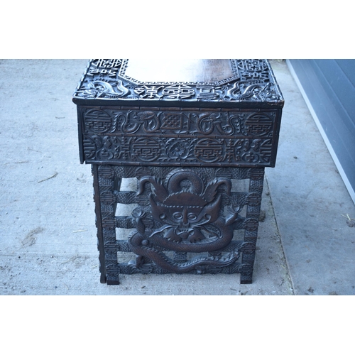 436 - Antique Chinese carved alter table with folding legs with carved figural decoration with character m... 