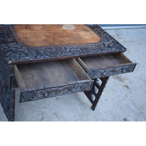 436 - Antique Chinese carved alter table with folding legs with carved figural decoration with character m... 