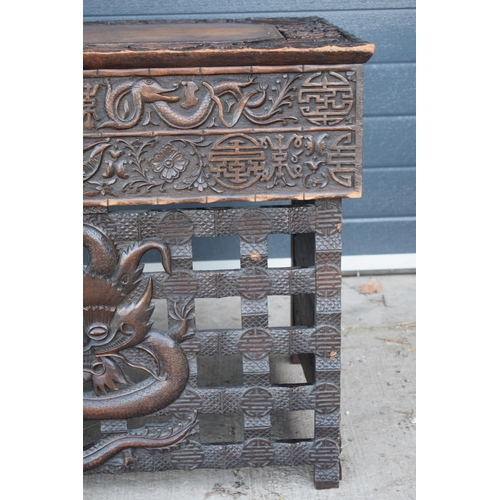 436 - Antique Chinese carved alter table with folding legs with carved figural decoration with character m... 