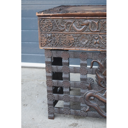 436 - Antique Chinese carved alter table with folding legs with carved figural decoration with character m... 