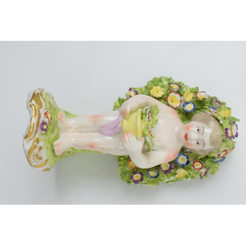 132 - Royal Doulton Sheikh figure (seconds) with a continental pottery figure of a cherub amongst foliage ... 