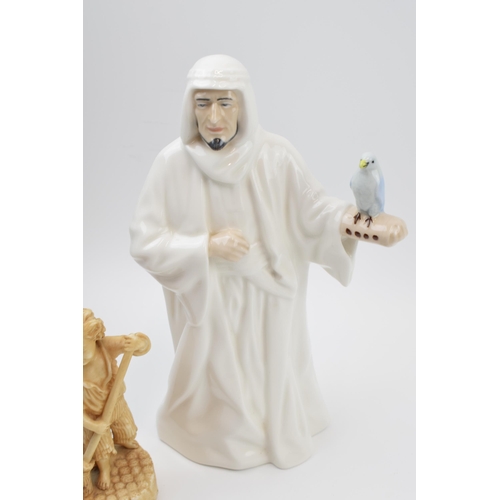 132 - Royal Doulton Sheikh figure (seconds) with a continental pottery figure of a cherub amongst foliage ... 