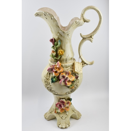 198 - Large Capo Di Monte floral jug with relief floral decoration, 66cm tall.