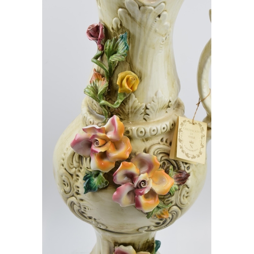 198 - Large Capo Di Monte floral jug with relief floral decoration, 66cm tall.