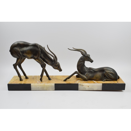 243A - French Art Deco figures of a pair of gazelles mounted onto onyx / marble base, 55cm long.