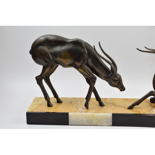 243A - French Art Deco figures of a pair of gazelles mounted onto onyx / marble base, 55cm long.