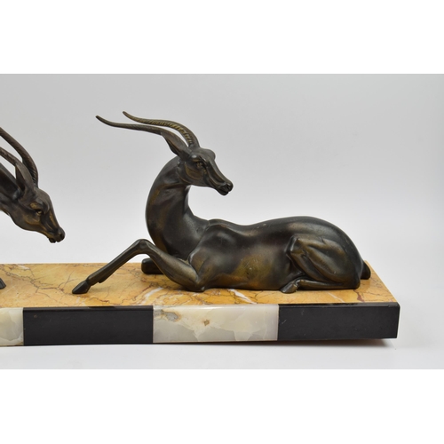 243A - French Art Deco figures of a pair of gazelles mounted onto onyx / marble base, 55cm long.