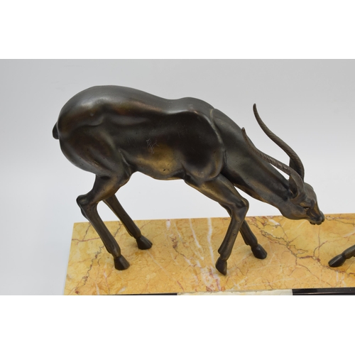 243A - French Art Deco figures of a pair of gazelles mounted onto onyx / marble base, 55cm long.