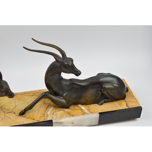 243A - French Art Deco figures of a pair of gazelles mounted onto onyx / marble base, 55cm long.