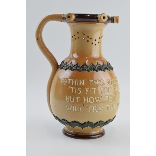 107 - Doulton Lambeth stoneware puzzle jug 'Within This Jug There Is Good Liquor....', 23cm tall.