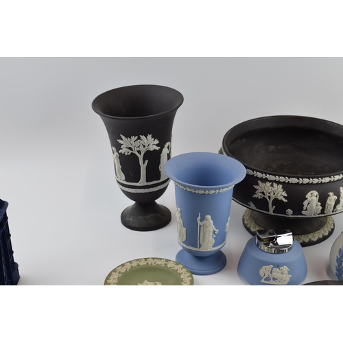 145 - Wedgwood Jasperware to include a black pedestal bowl, a lighter, a blue on white vase, vases and oth... 