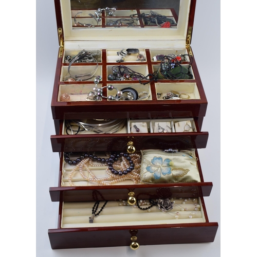 211 - A modern wooden jewellery case with folding lid and pull out drawers with a collection of costume je... 