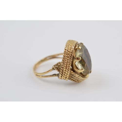 215 - 9ct gold chunky dress ring set with smoky stone, 9.4 grams gross weight, size Q.