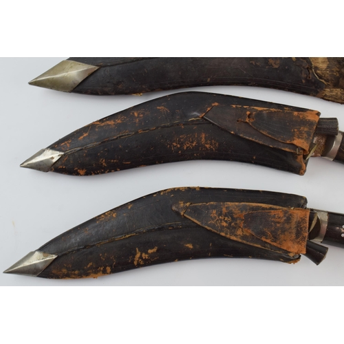 312 - A trio of vintage Gurkha Kukri knifes with leather scabbards, longest 42cm (3).