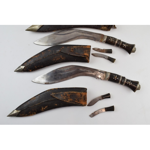 312 - A trio of vintage Gurkha Kukri knifes with leather scabbards, longest 42cm (3).