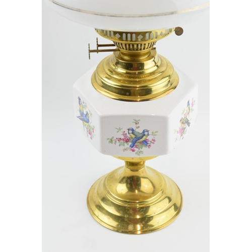 316 - Vintage brass oil lamp with ceramic decoration, 55cm tall.