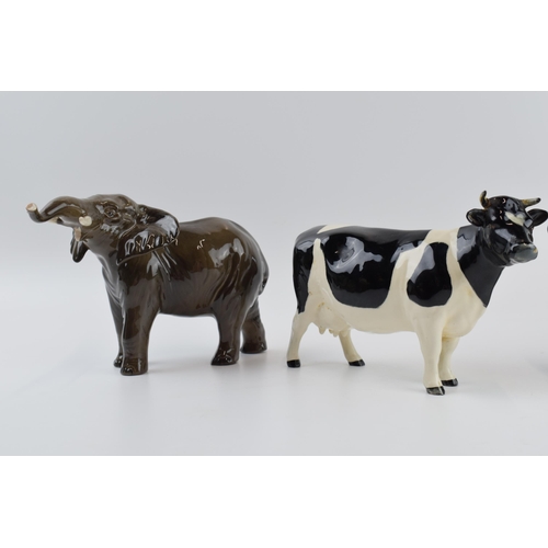 73 - A pair of Beswick elephants (1 nip to tusk) and a Friesian cow (1 horn af) (3).