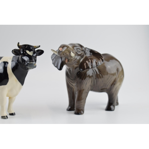 73 - A pair of Beswick elephants (1 nip to tusk) and a Friesian cow (1 horn af) (3).