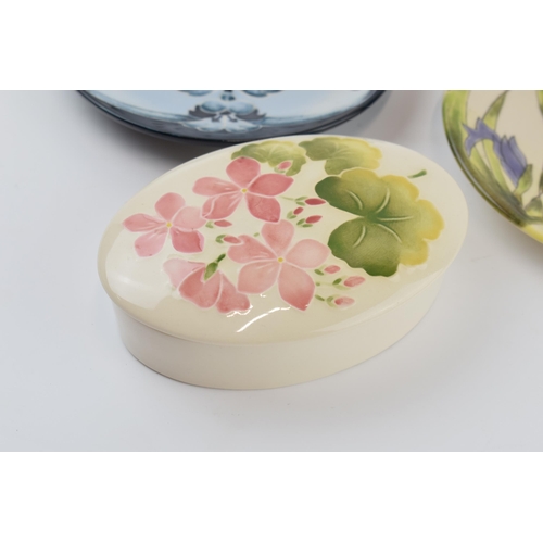 83 - A Moorcroft pink floral oval trinket box with 2 Cobridge Stoneware pin dishes, 15cm diameter (3).