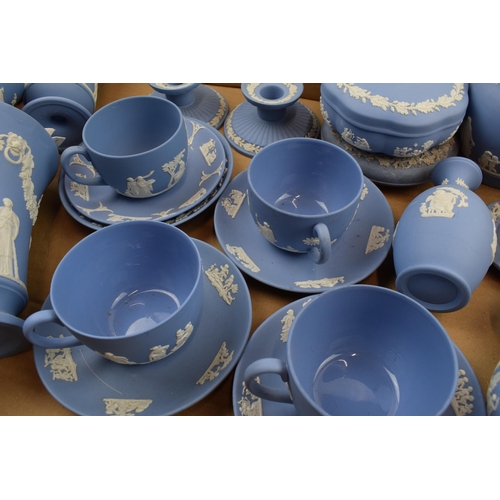 153 - Wedgwood Jasperware. A good collection of mixed Jasperware in blue. To include glazed cups and sauce... 