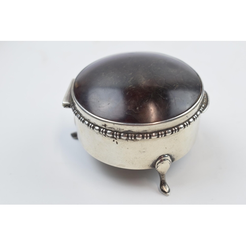 231M - Silver and tortoiseshell lidded trinket box, raised on 3 feet, Birmingham 1929, 7cm diameter.