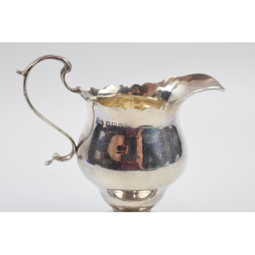 231O - Silver cream jug, Chester 1912, scroll handle, 48.4 grams.