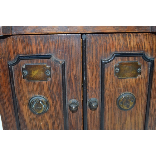 231W - Mid 20th century wooden cabinet with brass fittings marked 'Secure' with 3 drawers behind doors, 26x... 