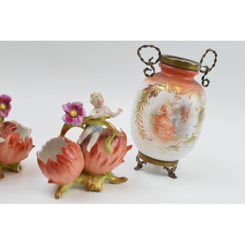 6 - A pair of painted glass vases mounted with gilt metal fittings with a pair of continental putti figu... 