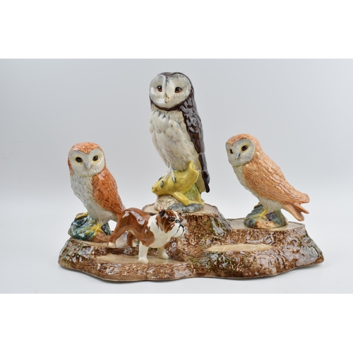 67 - Beswick to include a bird tree stump stand, a pair of barn owls (1 boxed), a boxer dog and a Whyte &... 