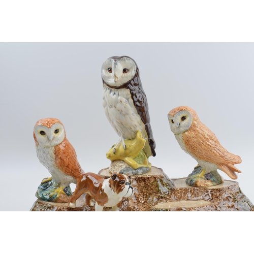 67 - Beswick to include a bird tree stump stand, a pair of barn owls (1 boxed), a boxer dog and a Whyte &... 